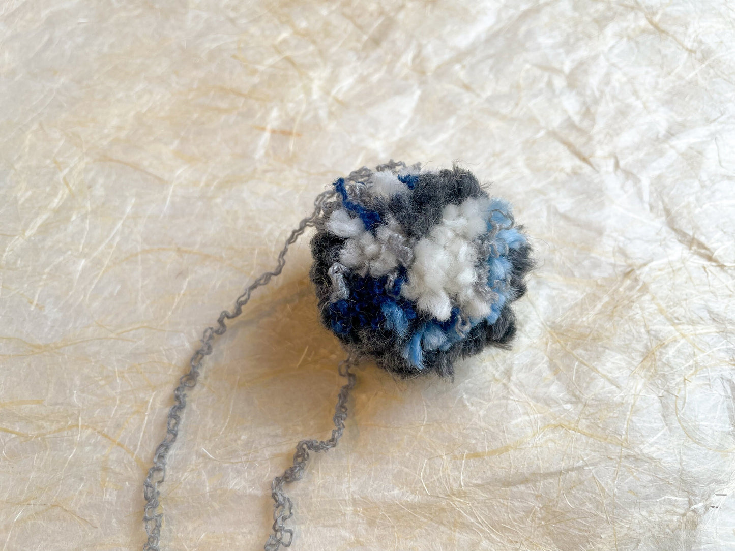 Handmade Blue, Navy, Gray, and Cream Pom-Pom Using 100% Reclaimed Materials