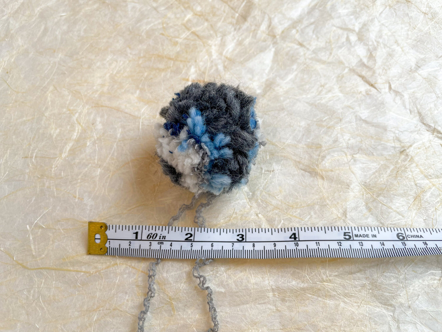 Handmade Blue, Navy, Gray, and Cream Pom-Pom Using 100% Reclaimed Materials