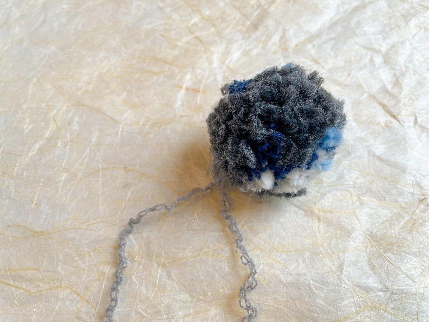 Handmade Blue, Navy, Gray, and Cream Pom-Pom Using 100% Reclaimed Materials