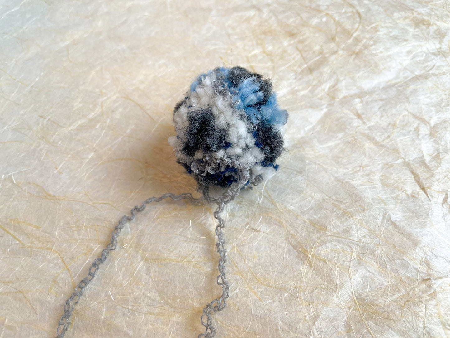Handmade Blue, Navy, Gray, and Cream Pom-Pom Using 100% Reclaimed Materials