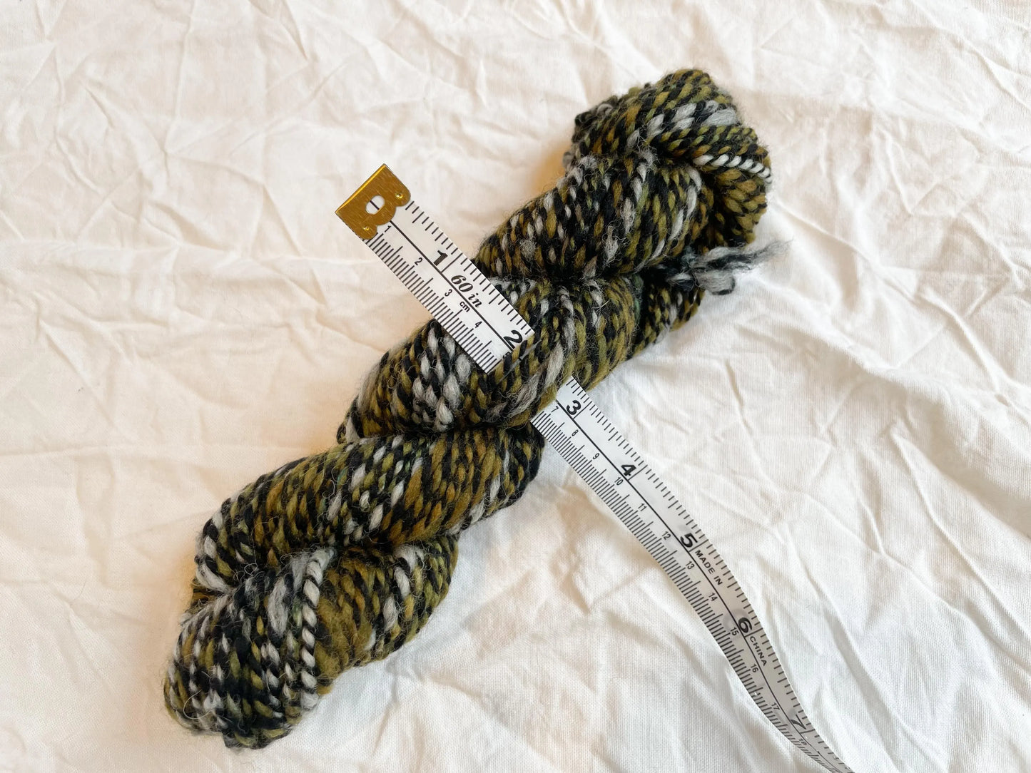 Handspun Randomly-Striped Newspaper Green Marled Yarn Using Merino Wool and Recycled Materials
